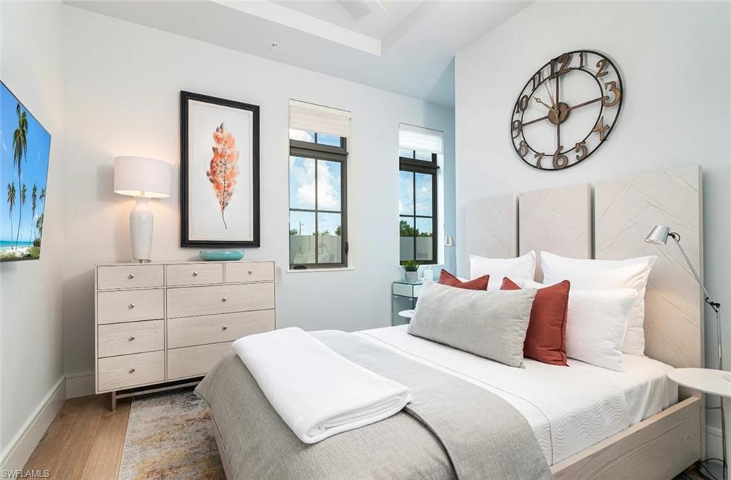 101 8th Street South, Unit 206 Naples, FL 34102 - Photo 6 of 15 a bedroom with a bed and a closet