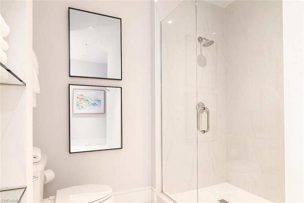 101 8th Street South, Unit 206 Naples, FL 34102 - Photo 8 of 15 a bathroom with a toilet sink and shower