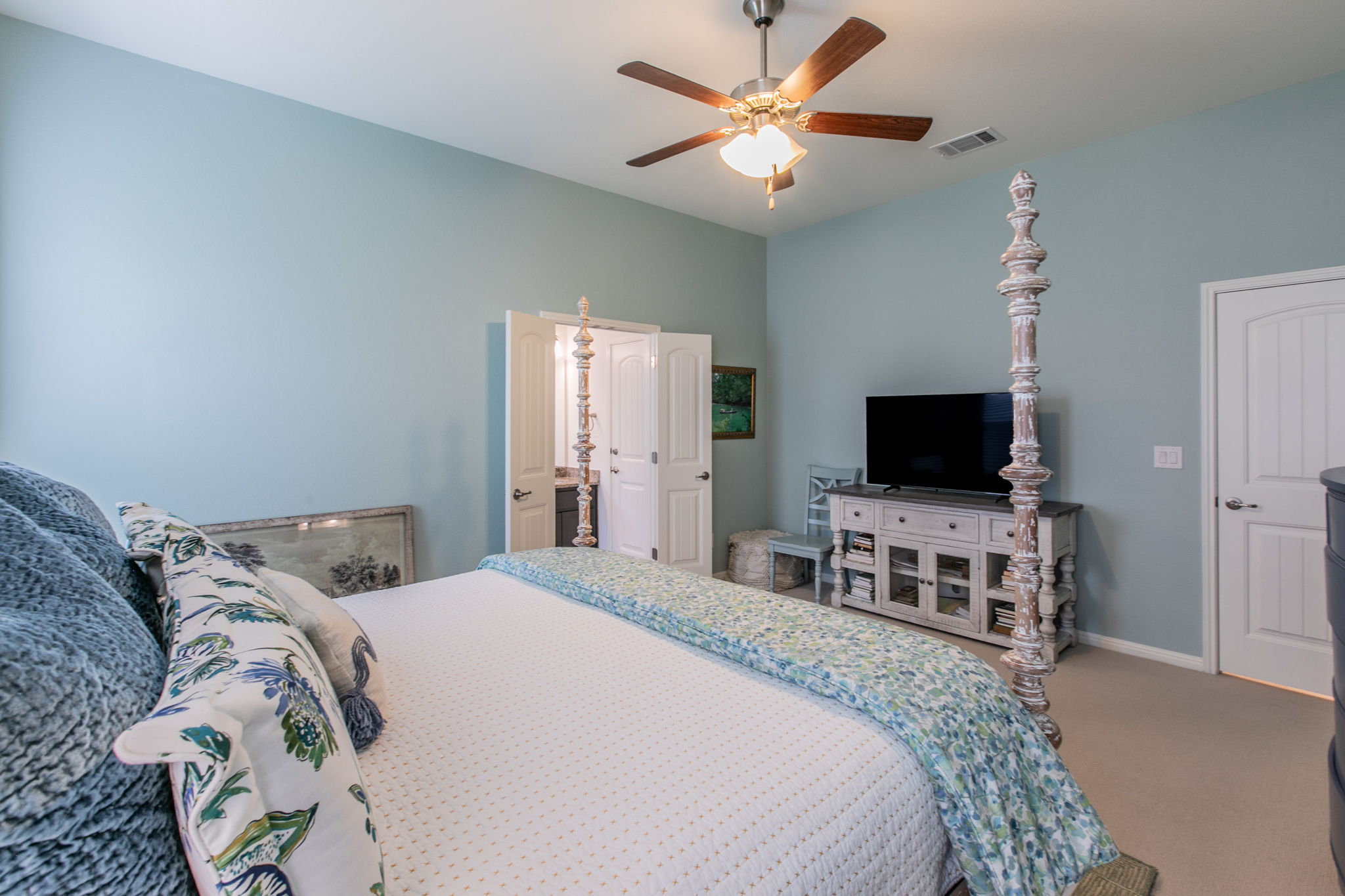 231 Simon Kyle, TX 78640 - Photo 14 of 29 Spacious bedroom featuring light blue walls, a ceiling fan with integrated lighting, and carpeted flooring