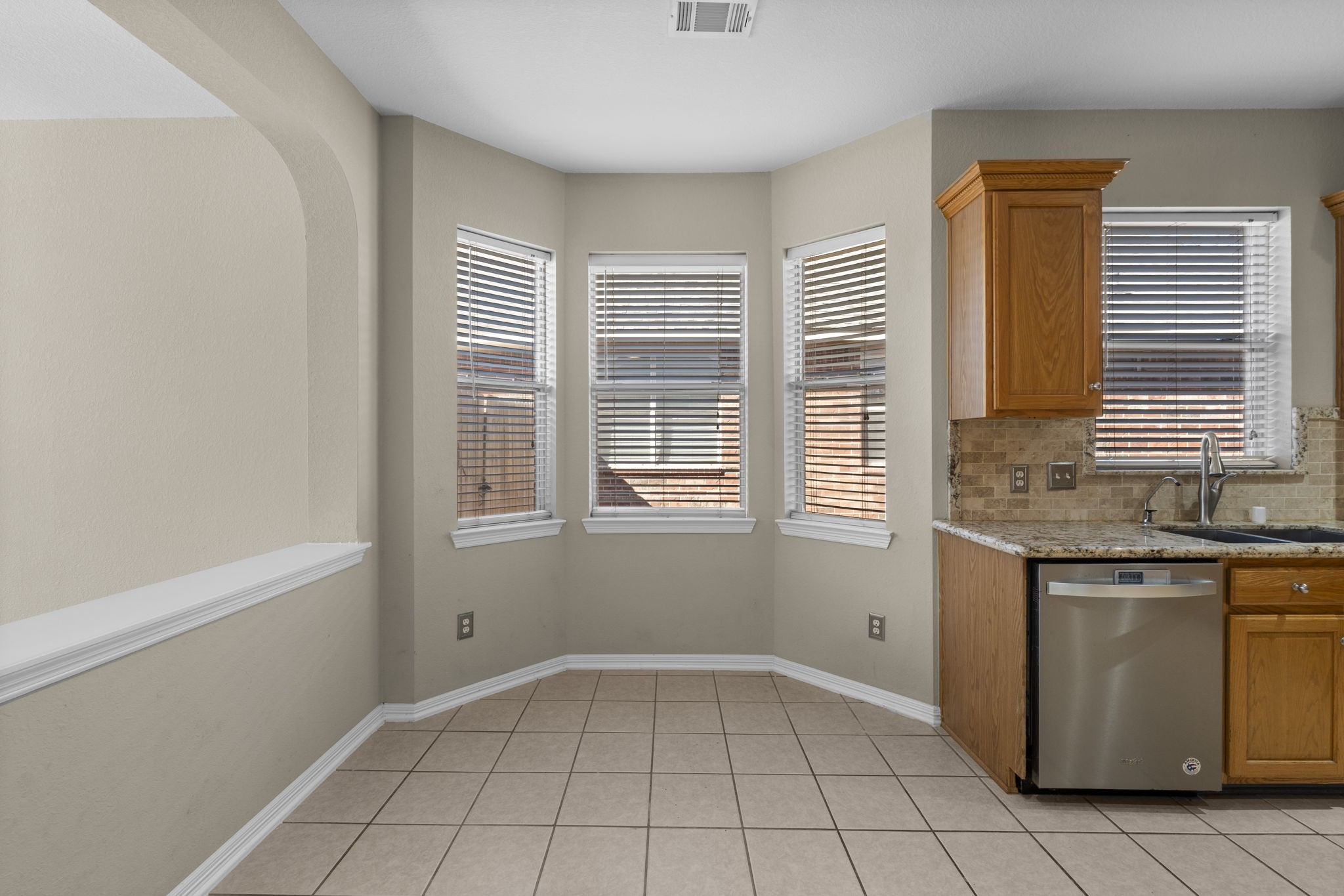 19327 Dickson Park Drive Spring, TX 77373 - Photo 14 of 43 Start your mornings with a cup of coffee or gather for family dinners in this inviting light-filled breakfast area featuring tile flooring, bay window with 2” blinds, and clean recessed lighting.