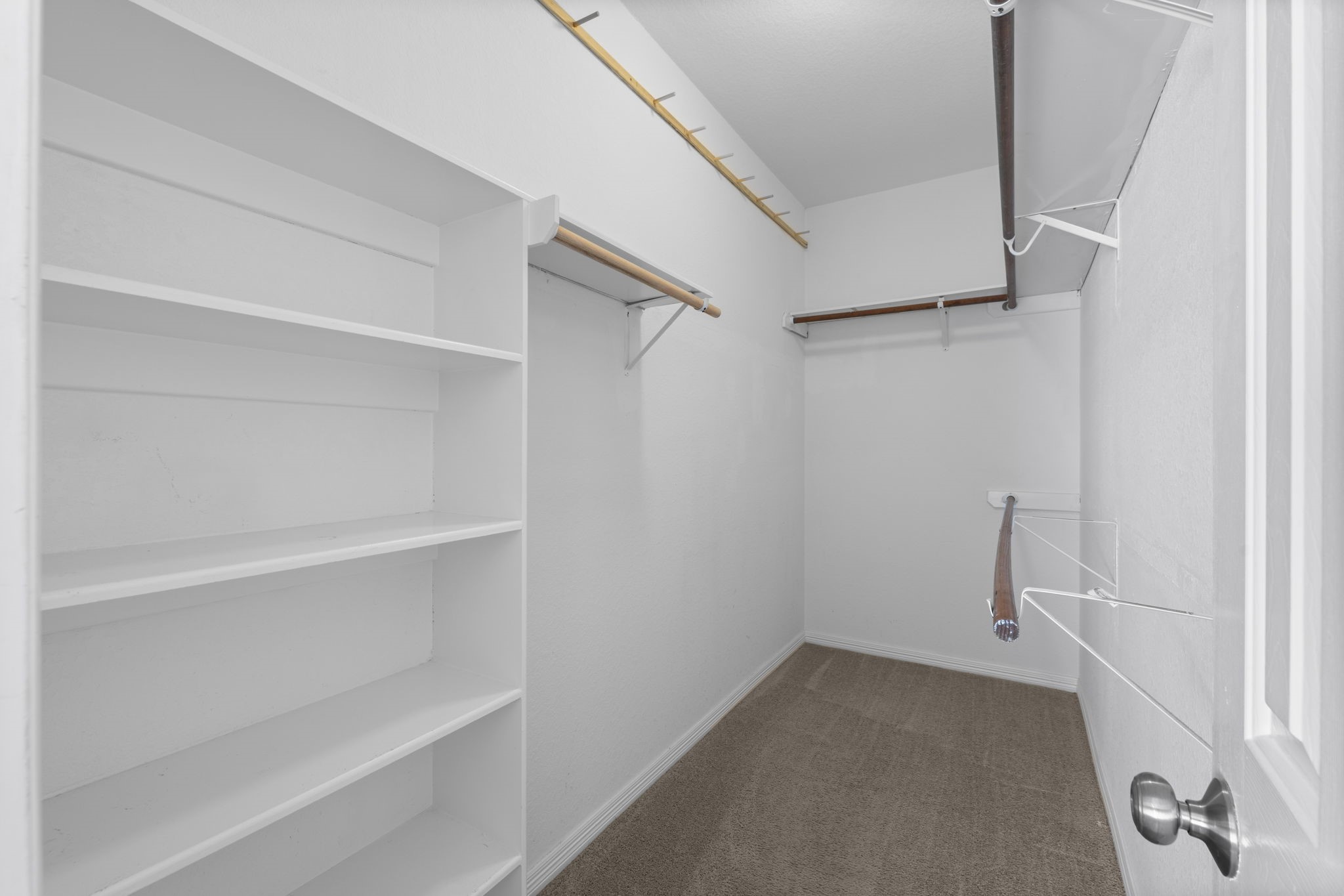 19327 Dickson Park Drive Spring, TX 77373 - Photo 20 of 43 There’s no need to compromise on space with this large 12' long walk-in closet in the Owner’s Suite. It features built-in shelving and ample hanging space— offering the perfect blend of function and elegance. Thoughtfully designed to keep everything organized and beautifully displayed, this closet is a dream for anyone who values space, style, and convenience.