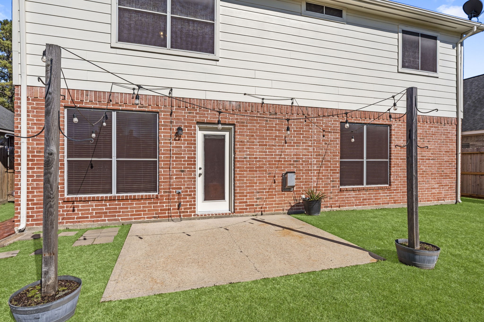 19327 Dickson Park Drive Spring, TX 77373 - Photo 36 of 43 Entertain under the stars on this inviting patio accented with bistro lighting. A dedicated block area accommodates a grill, with ample space for outdoor dining or lounge furnishings.