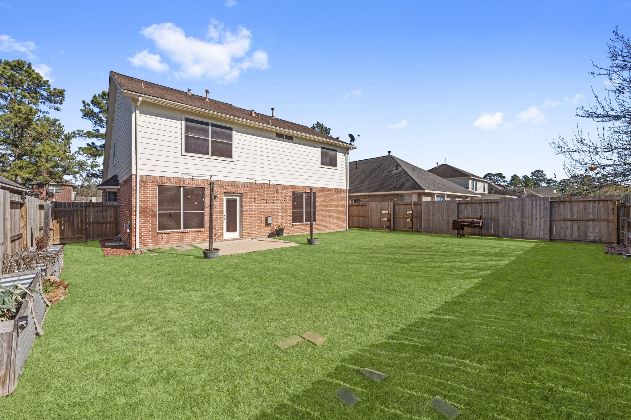19327 Dickson Park Drive Spring, TX 77373 - Photo 38 of 43 The yard is filled with abundant sunshine, creating a bright and cheerful atmosphere. The home is equipped with front and back gutters, making rainwater management a breeze and keeping the exterior well-maintained.