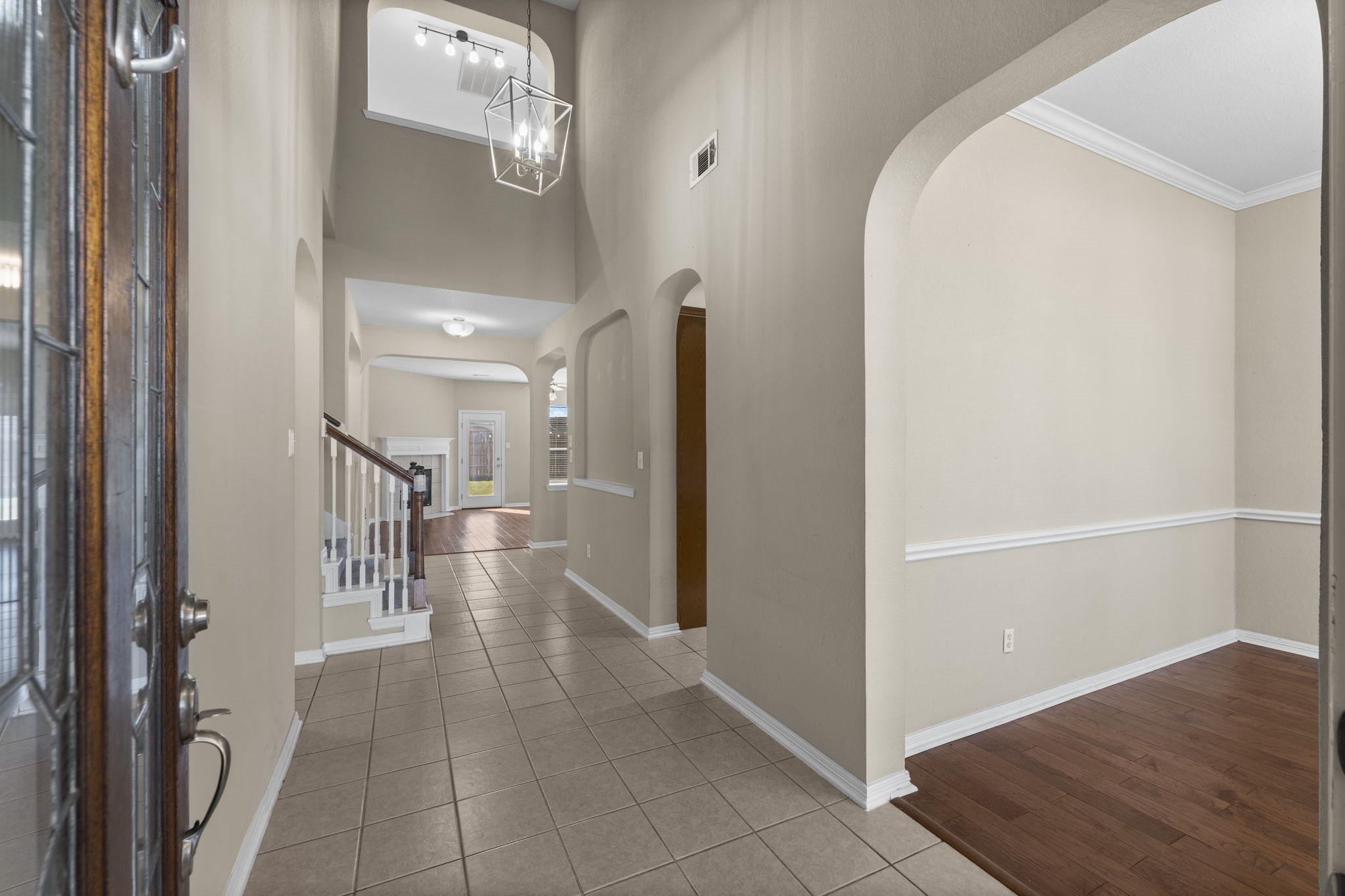 19327 Dickson Park Drive Spring, TX 77373 - Photo 41 of 43 Step into sophisticated style, where every detail is designed to impress. This two story soaring foyer features tile flooring, arched entryways, an art niche, and designer chandelier. With views of the entire downstairs from this entry, you can appreciate the open floor plan and natural lighting.