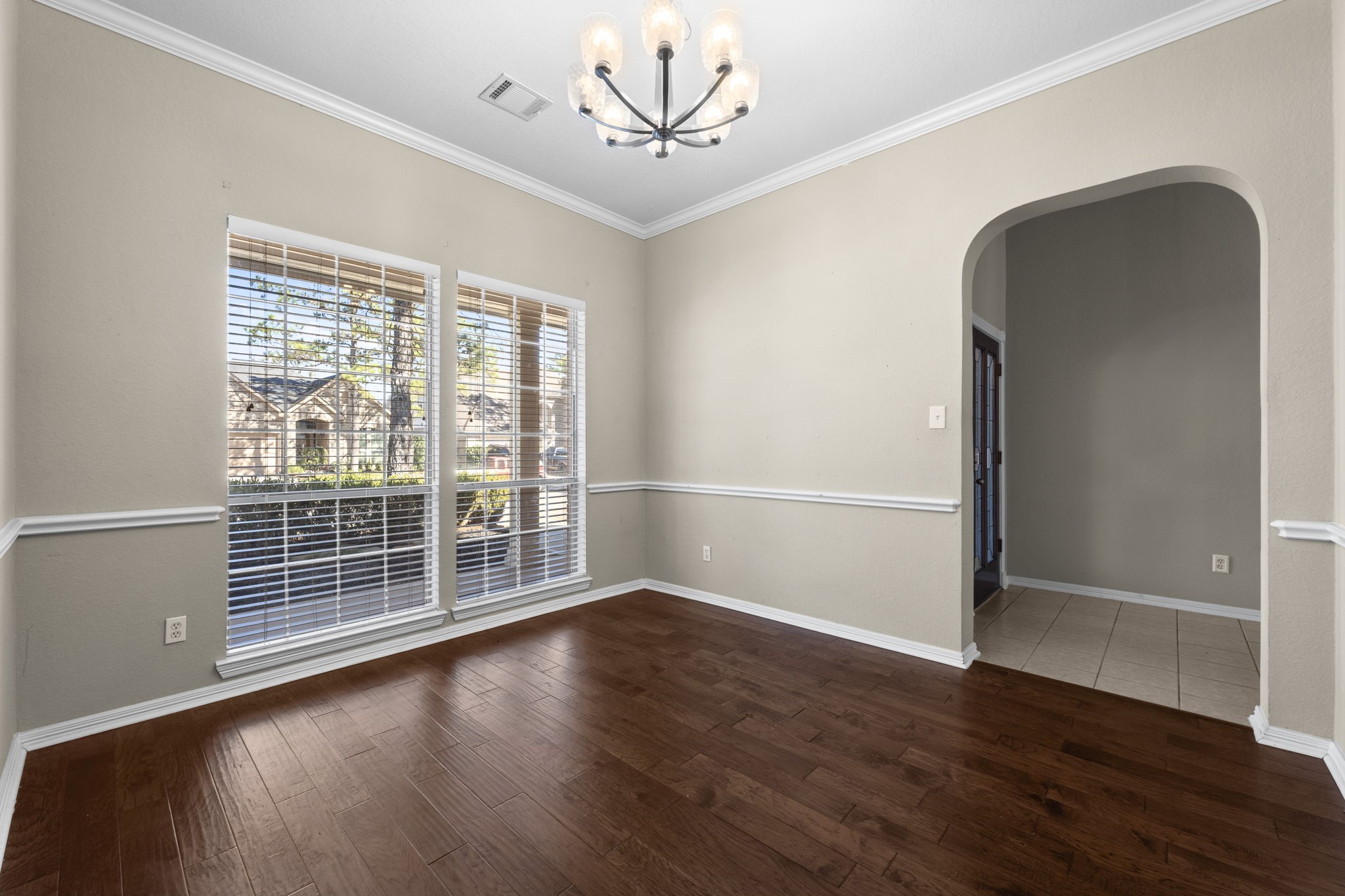 19327 Dickson Park Drive Spring, TX 77373 - Photo 6 of 43 Dine in elegance in this stunning Formal Dining Room, where arched entryways, large windows, and beautiful moldings create the perfect ambiance for entertaining. Whether hosting a dinner party or enjoying a quiet meal, this space adds a touch of luxury to every occasion.