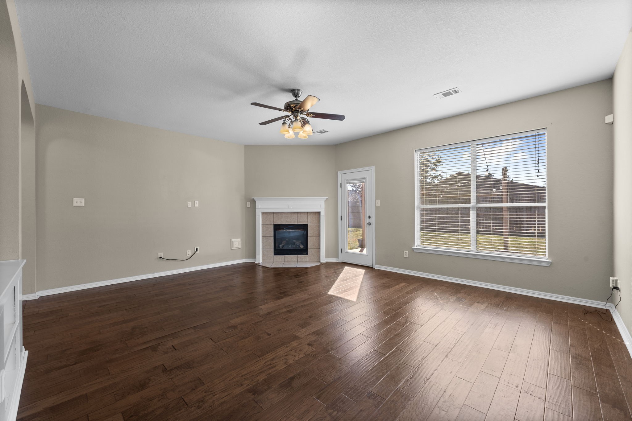 19327 Dickson Park Drive Spring, TX 77373 - Photo 8 of 43 Relax and unwind in this warm and welcoming Family Room, where a large double window frames views of the spacious backyard and patio. The backyard is easily accessed from the rear door, making entertaining a breeze.