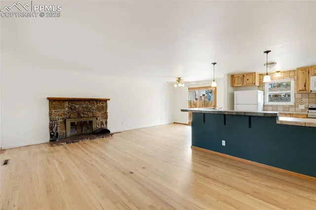 a view of kitchen and hall with wooden floor