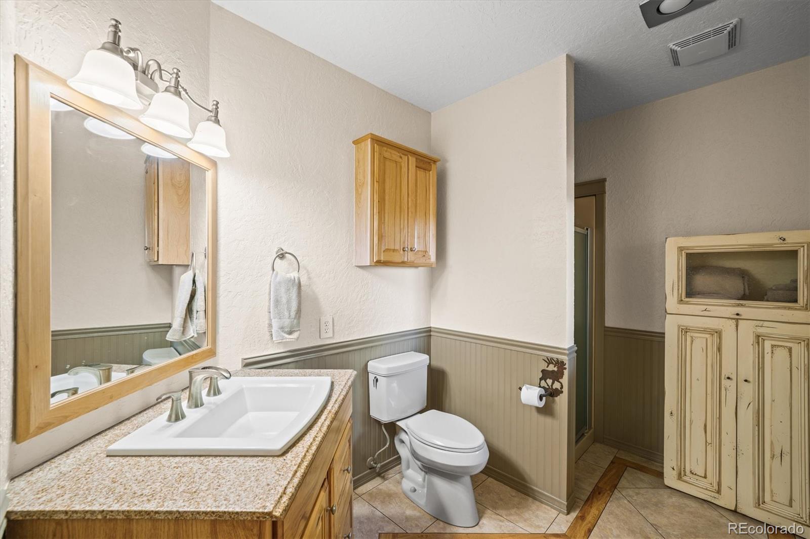3665 Colard Lane Lyons, CO 80540 - Photo 15 of 50 a bathroom with a granite countertop sink toilet and shower