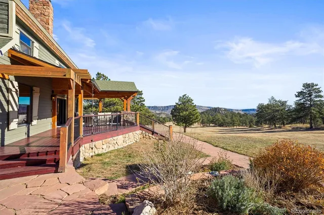 an aerial view of house with yard and mountain view in back