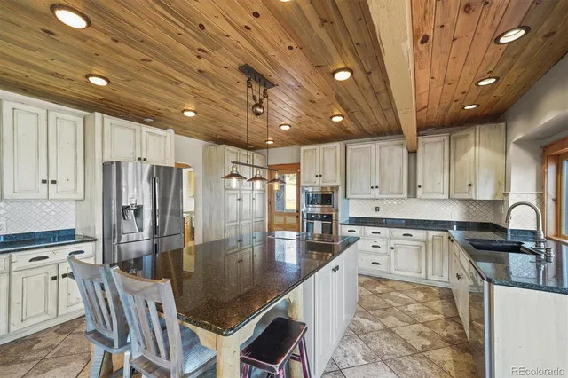 a kitchen with granite countertop a sink and cabinets