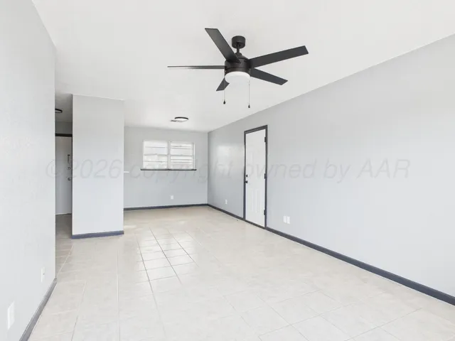 an empty room with closet and windows