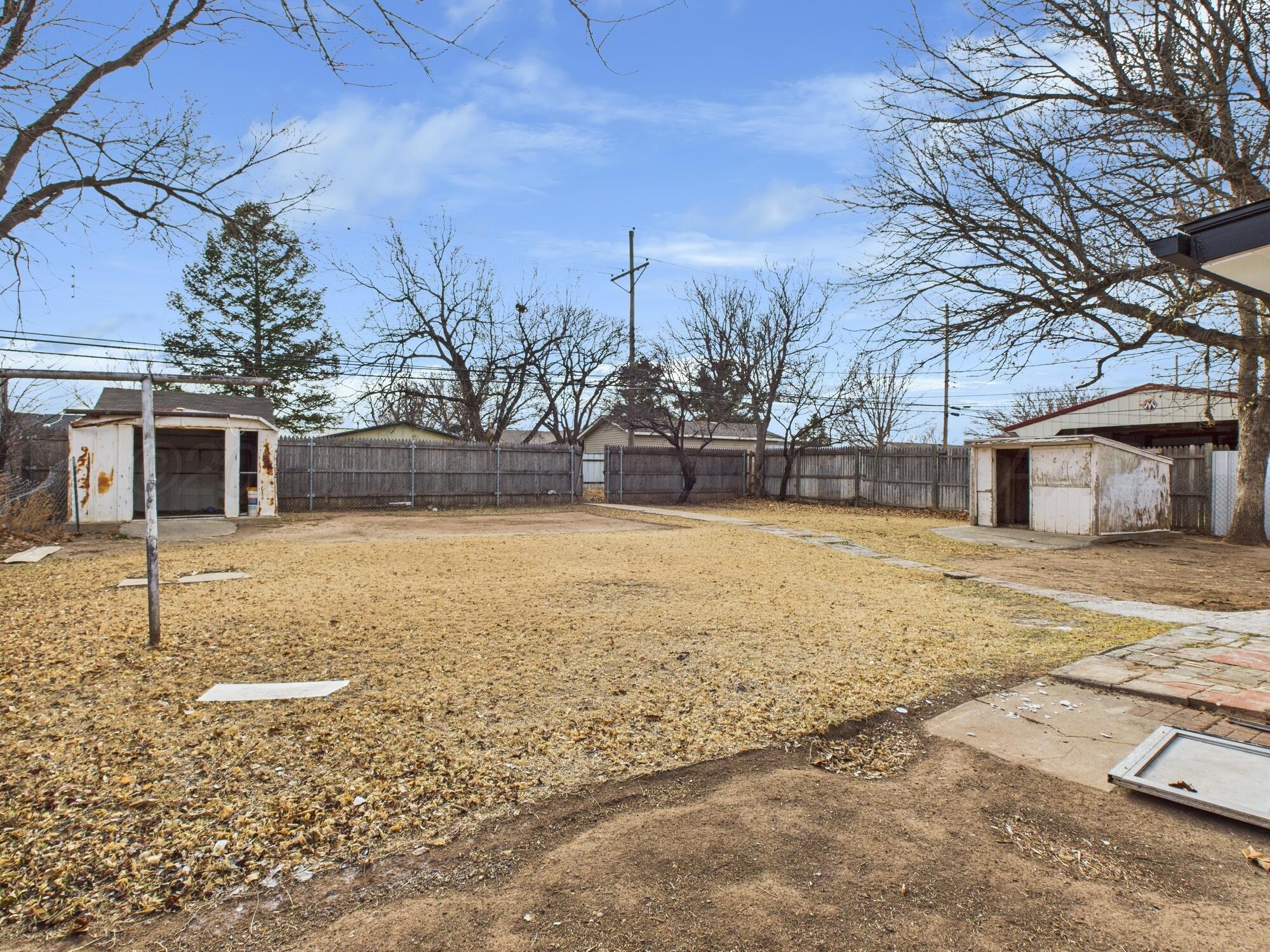 1002 Northeast 4th Street Dumas, TX 79029 - Photo 8 of 8 a view of a yard with a house
