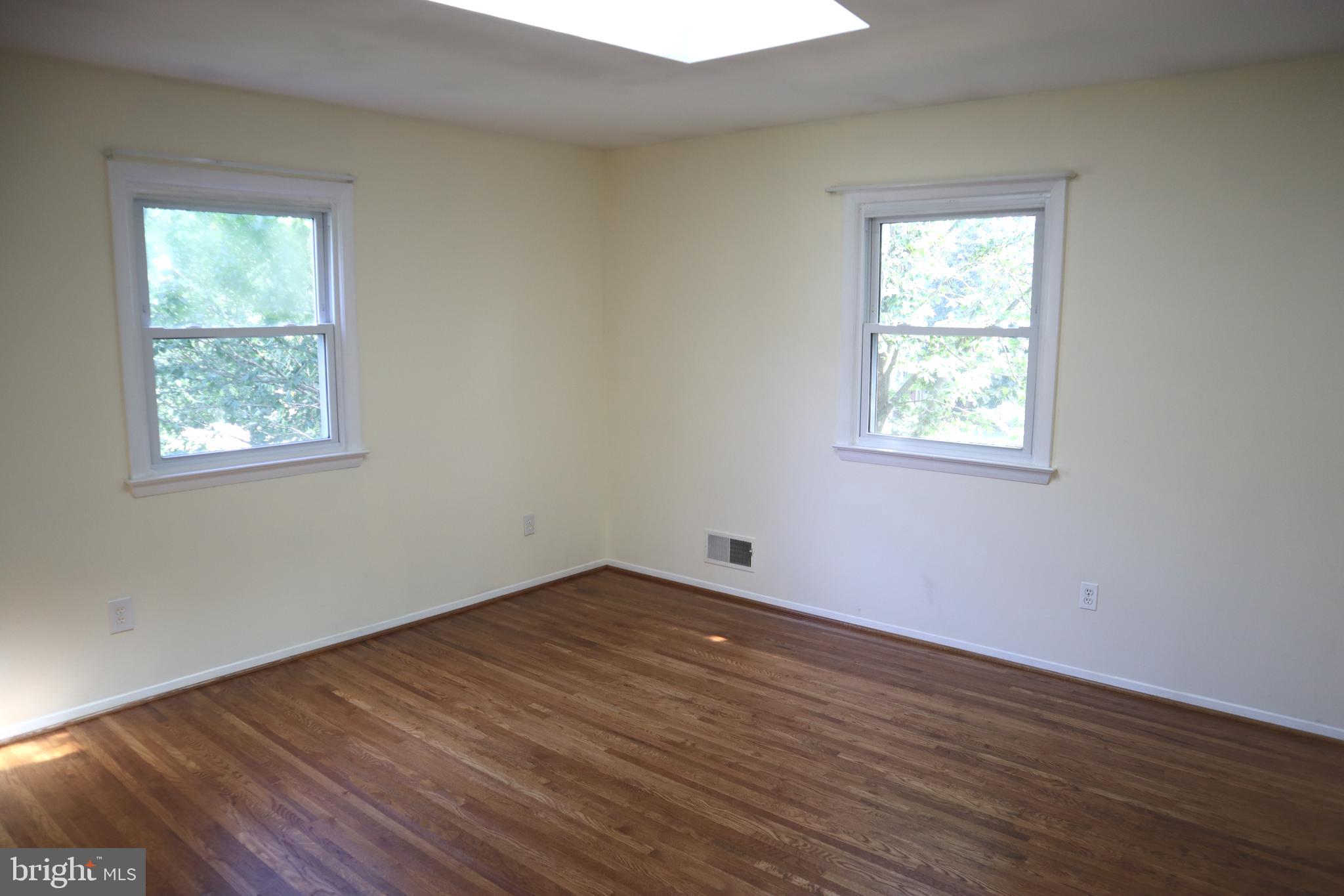 8501 Fairburn Drive Springfield, VA 22152 - Photo 11 of 30 an empty room with wooden floor and windows