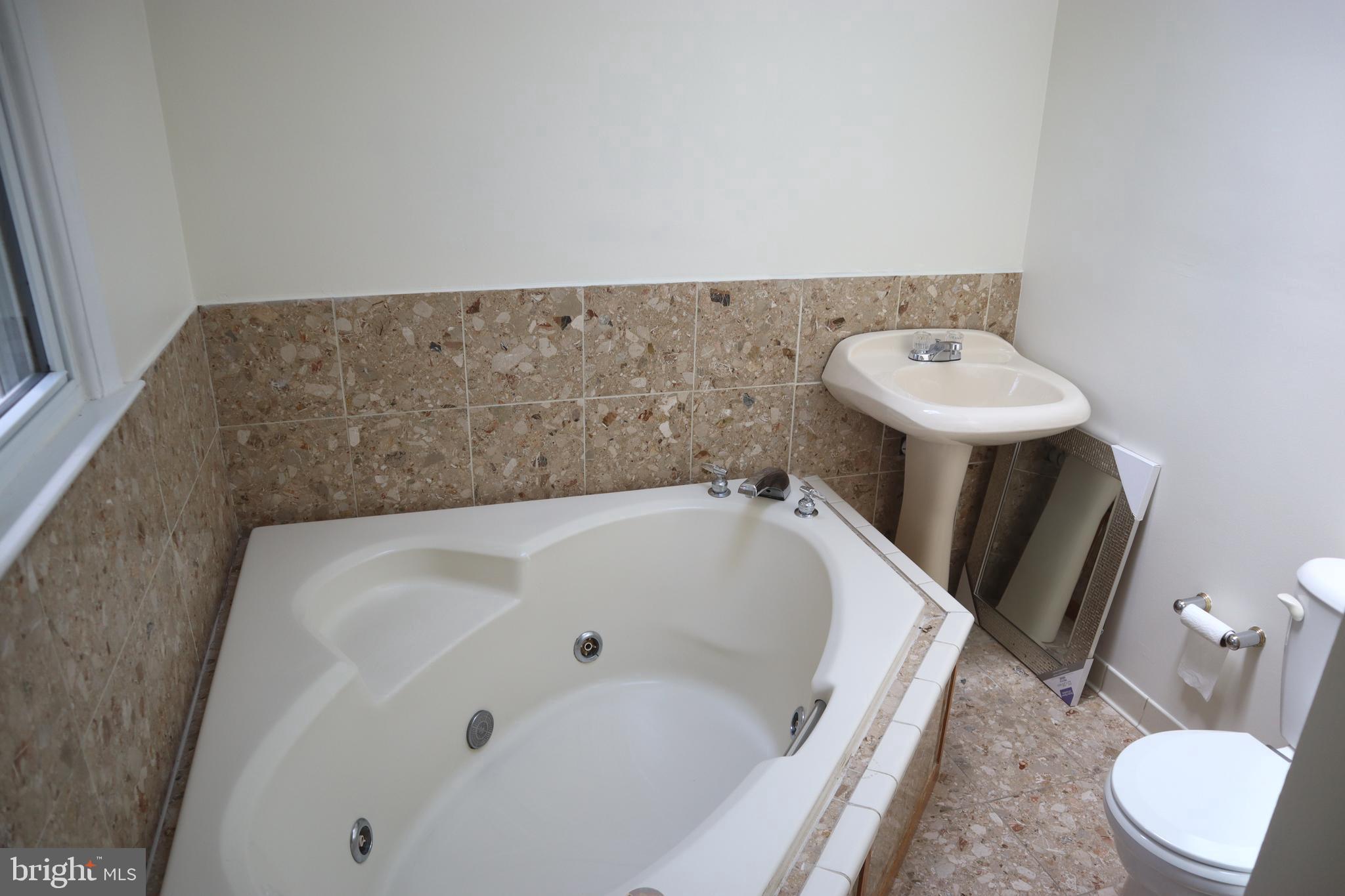8501 Fairburn Drive Springfield, VA 22152 - Photo 12 of 30 a bathroom with a tub sink and toilet
