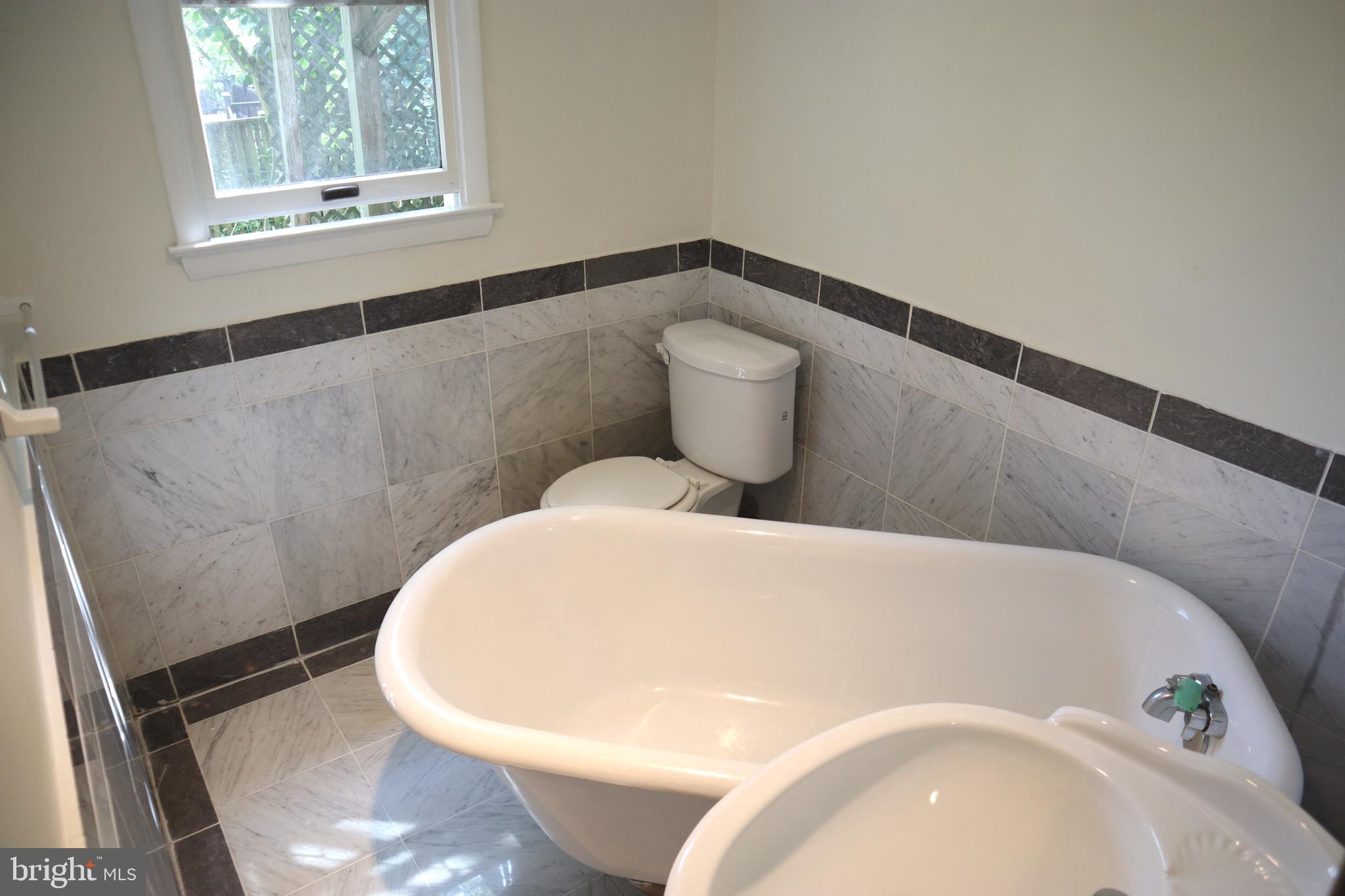 8501 Fairburn Drive Springfield, VA 22152 - Photo 17 of 30 a white bath tub sitting in a bathroom
