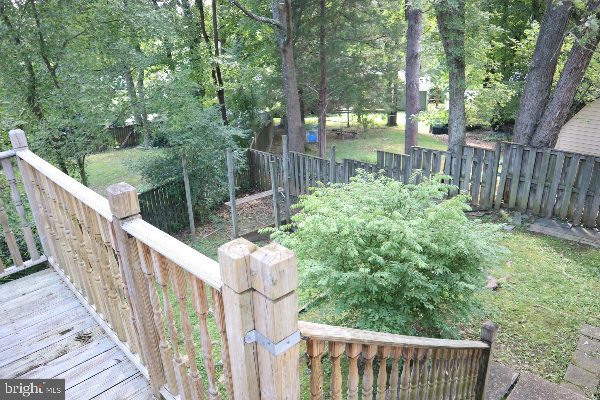 8501 Fairburn Drive Springfield, VA 22152 - Photo 25 of 30 a view of a pathway of a house with wooden floor and fence