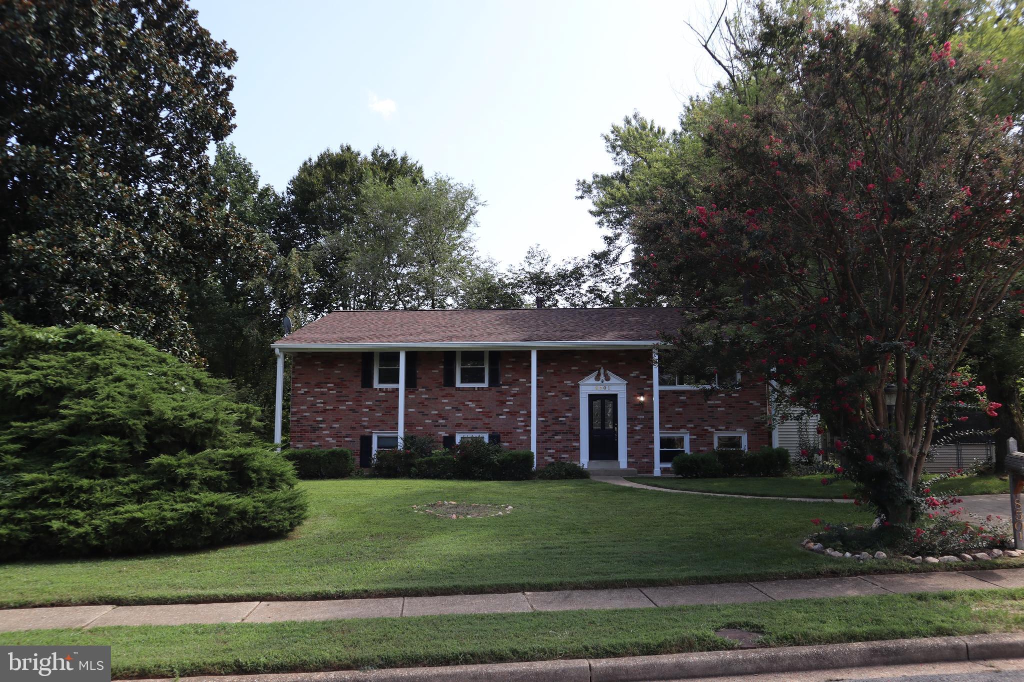 8501 Fairburn Drive Springfield, VA 22152 - Photo 30 of 30 a front view of a house with a garden