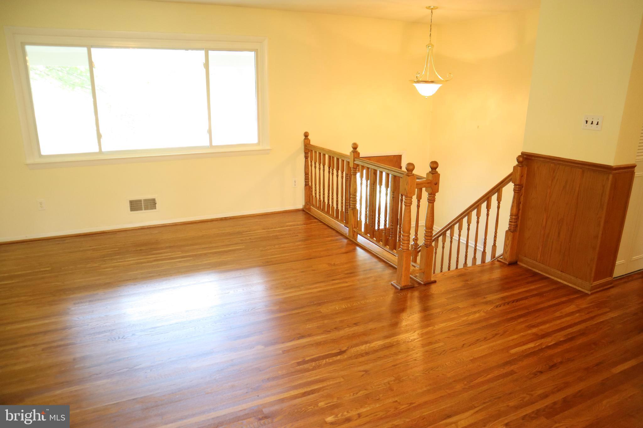 8501 Fairburn Drive Springfield, VA 22152 - Photo 4 of 30 a view of an empty room with wooden floor and a window