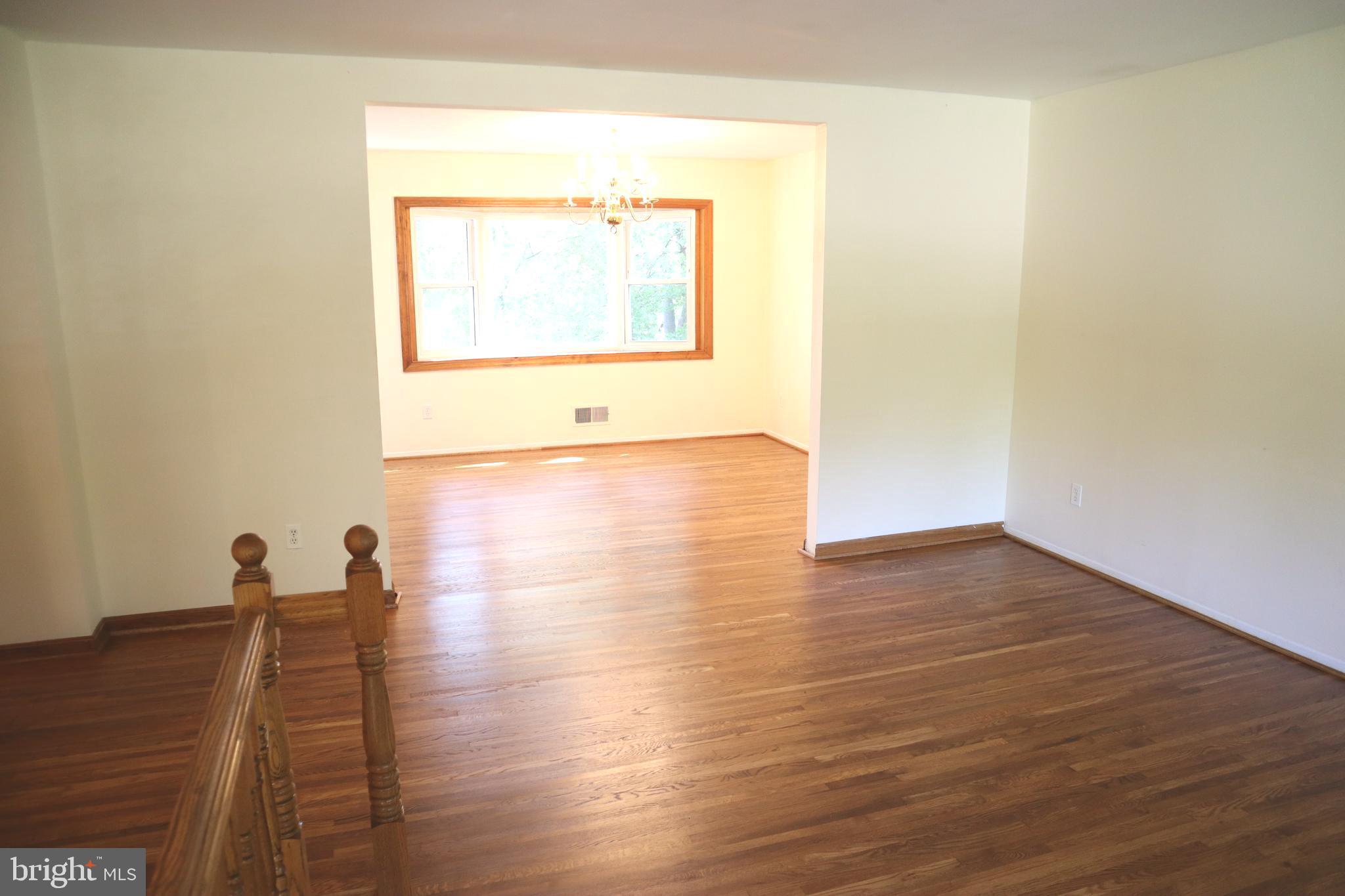 8501 Fairburn Drive Springfield, VA 22152 - Photo 5 of 30 a view of empty room with wooden floor and fan