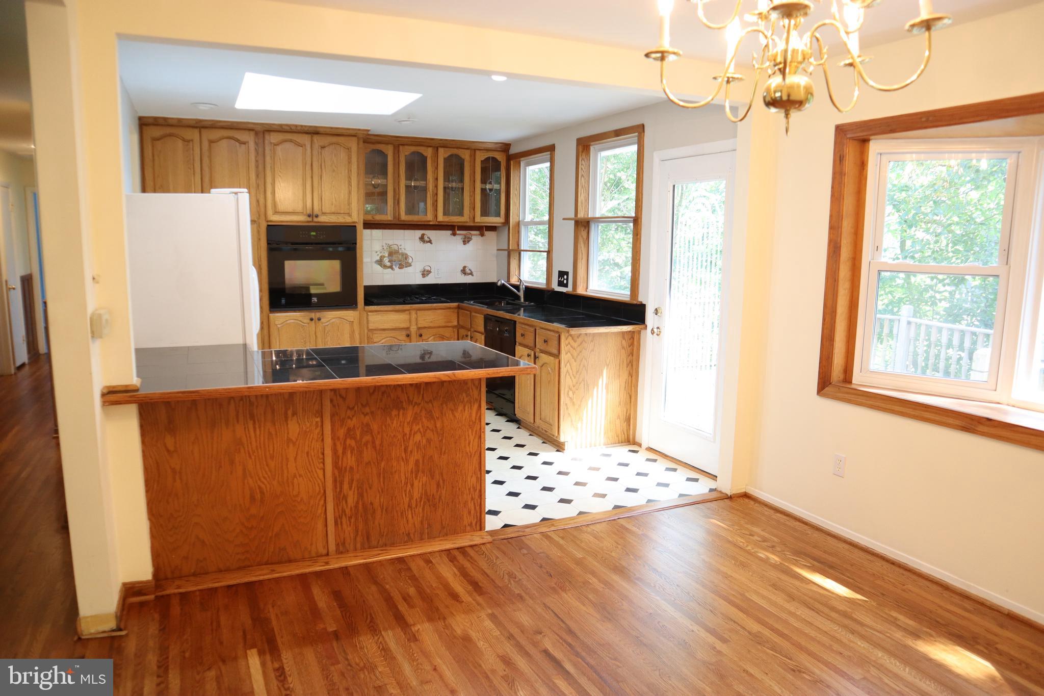 8501 Fairburn Drive Springfield, VA 22152 - Photo 6 of 30 a kitchen with stainless steel appliances granite countertop a refrigerator and a sink