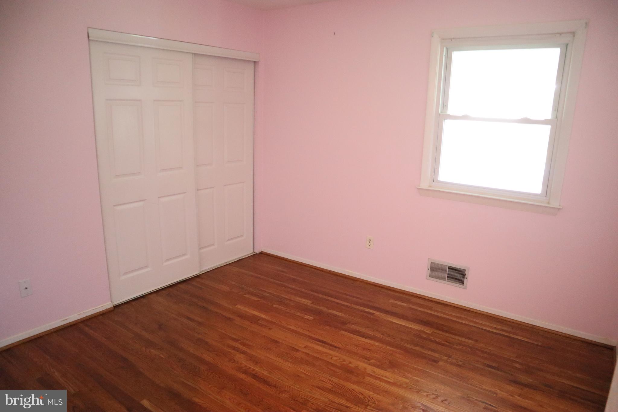 8501 Fairburn Drive Springfield, VA 22152 - Photo 7 of 30 an empty room with wooden floor and windows