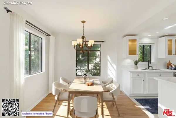 a dining room with furniture a chandelier and wooden floor