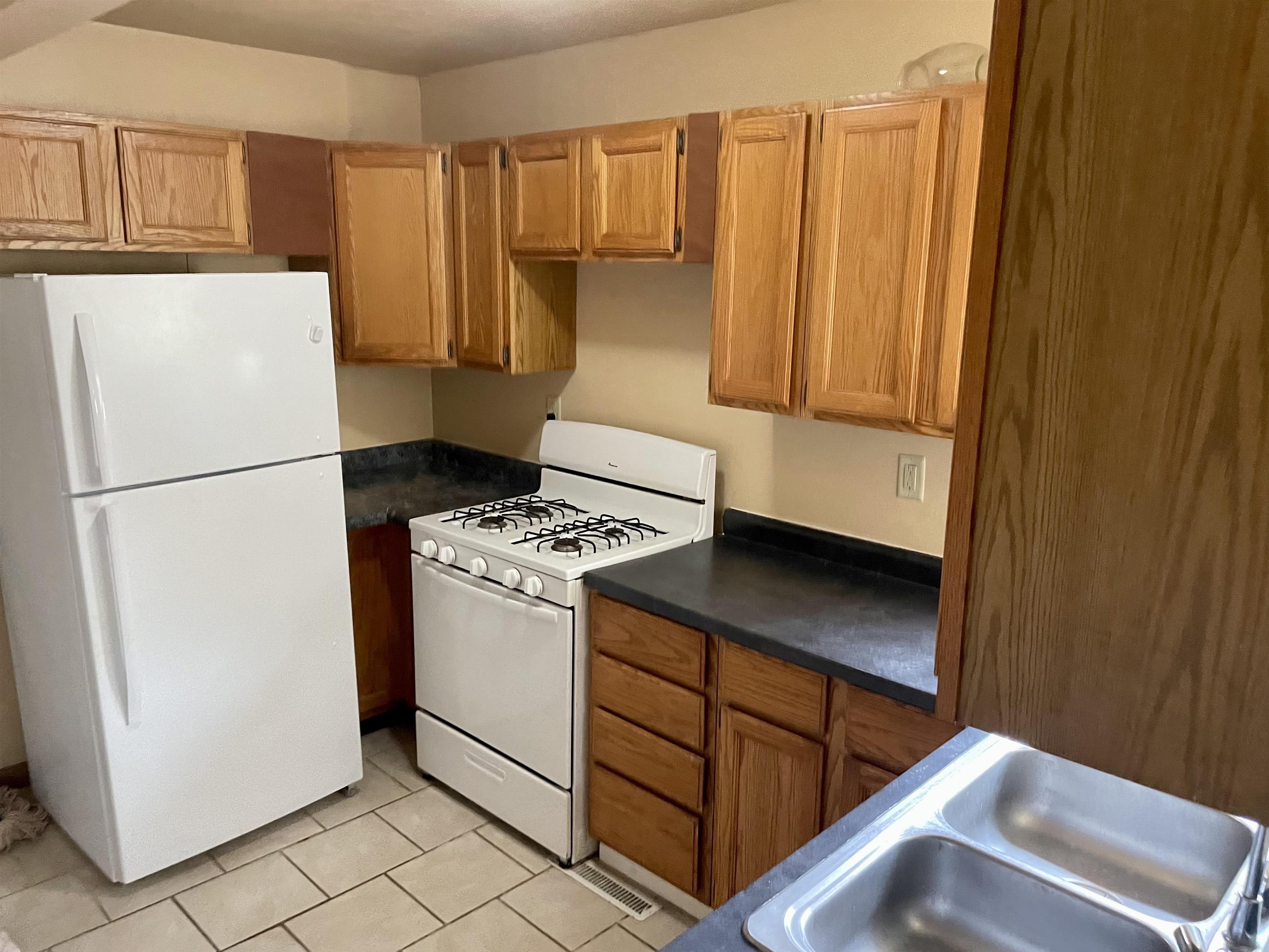 524 Brooke Road Rockford, IL 61109 - Photo 4 of 11 a kitchen with a refrigerator and a stove