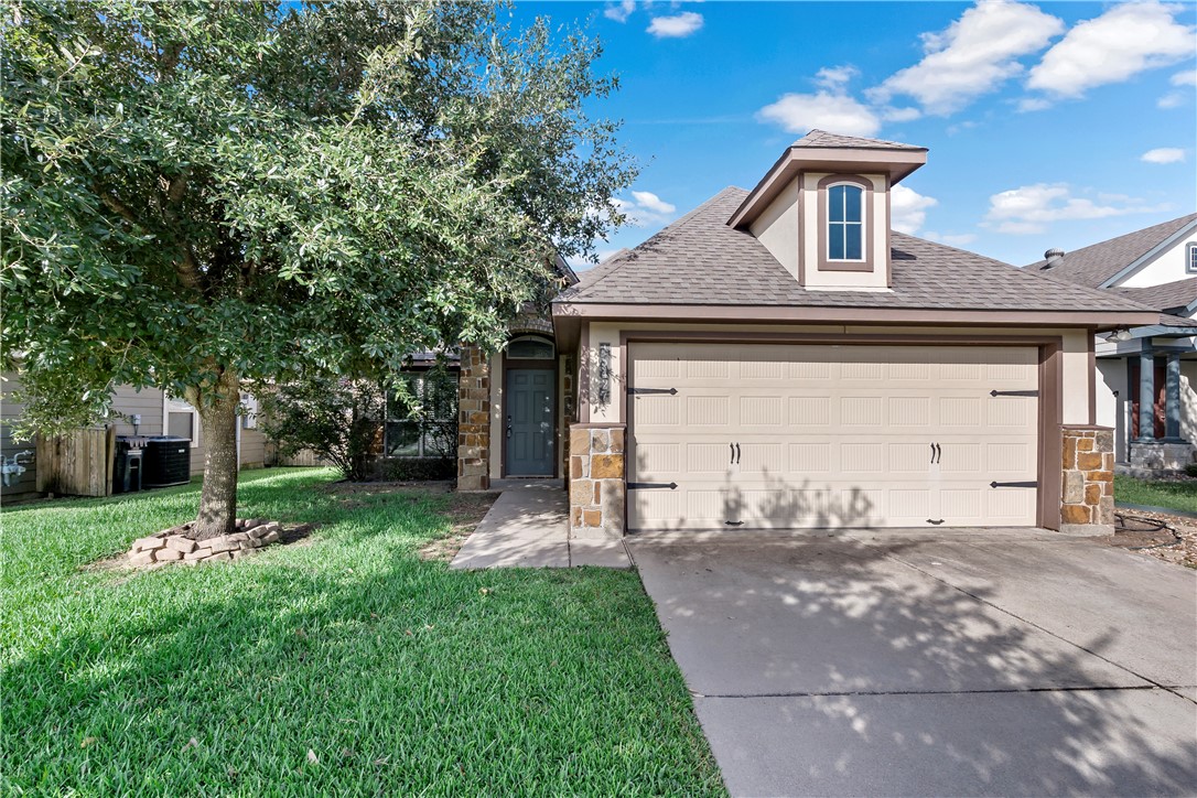 15427 Baker Meadow Loop College Station, TX 77845 - Photo 1 of 21 a front view of a house with a yard and garage