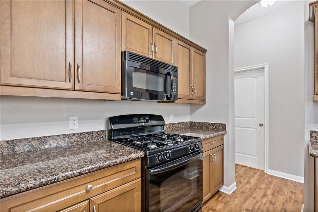 15427 Baker Meadow Loop College Station, TX 77845 - Photo 11 of 21 a kitchen with granite countertop white cabinets and stainless steel appliances