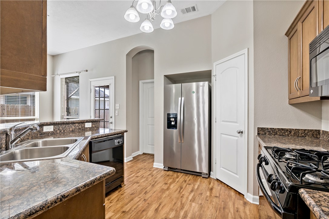 15427 Baker Meadow Loop College Station, TX 77845 - Photo 13 of 21 a kitchen that has a sink stainless steel appliances a counter space and a window