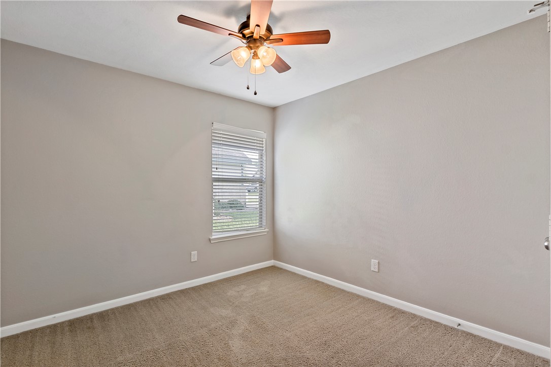 15427 Baker Meadow Loop College Station, TX 77845 - Photo 16 of 21 an empty room with windows and fan