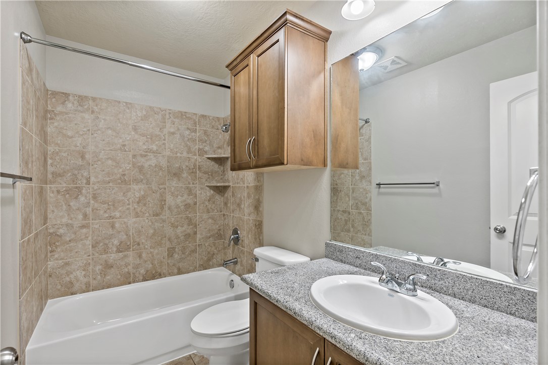 15427 Baker Meadow Loop College Station, TX 77845 - Photo 17 of 21 a bathroom with a sink a toilet and a bathtub