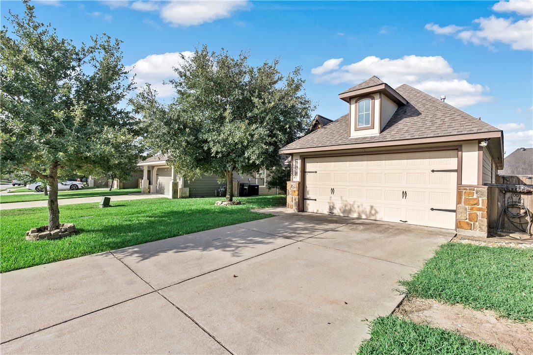 15427 Baker Meadow Loop College Station, TX 77845 - Photo 2 of 21 a front view of a house with a yard and garage