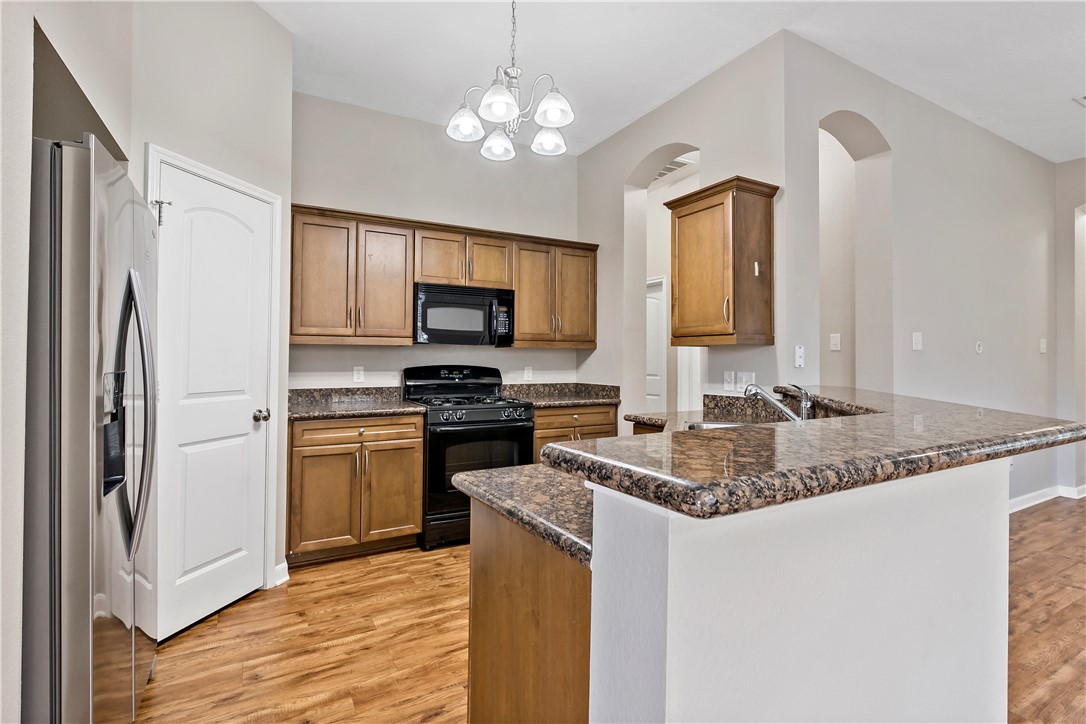 15427 Baker Meadow Loop College Station, TX 77845 - Photo 10 of 21 a kitchen with stainless steel appliances granite countertop a refrigerator a stove top oven a sink and dishwasher