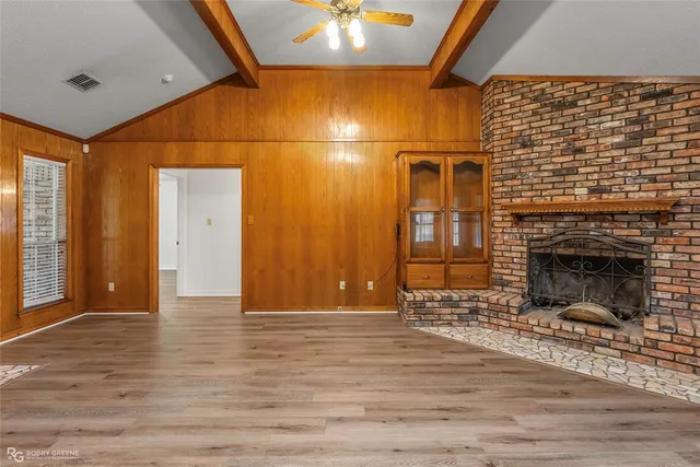 a view of a livingroom with a fireplace and window