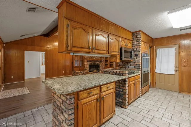 a kitchen with stainless steel appliances granite countertop a sink and cabinets
