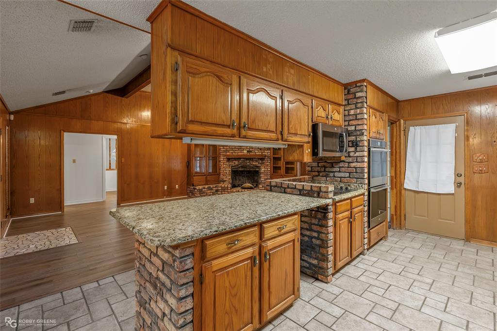 5425 Modica Lott Road Bossier City, LA 71111 - Photo 19 of 31 a kitchen with stainless steel appliances granite countertop a sink and cabinets