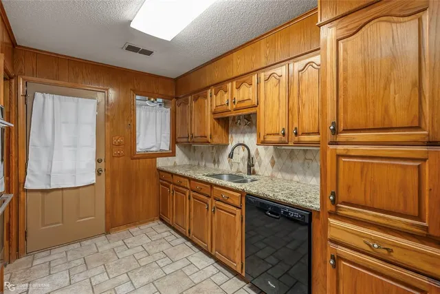 a kitchen with stainless steel appliances granite countertop a sink and cabinets