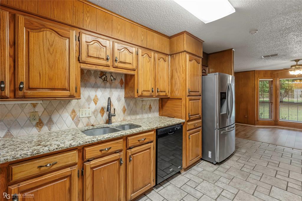 5425 Modica Lott Road Bossier City, LA 71111 - Photo 23 of 31 a kitchen with stainless steel appliances granite countertop a refrigerator and a sink