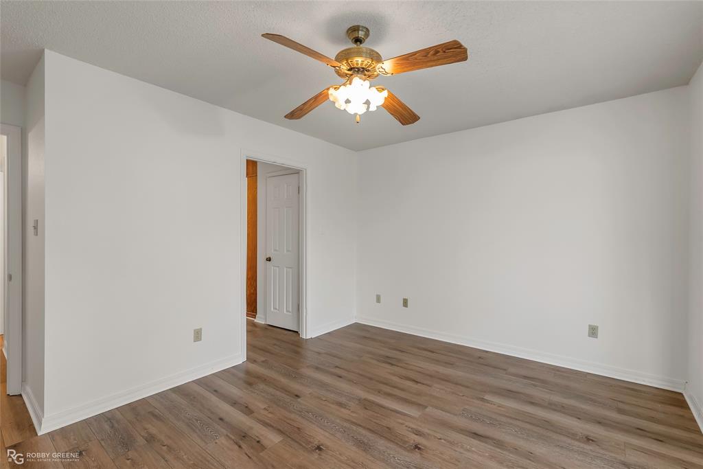 5425 Modica Lott Road Bossier City, LA 71111 - Photo 28 of 31 an empty room with wooden floor and a ceiling fan