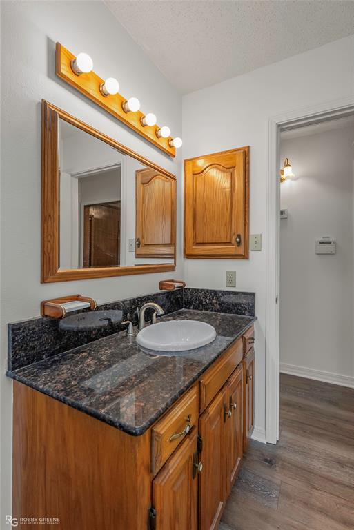 5425 Modica Lott Road Bossier City, LA 71111 - Photo 29 of 31 a bathroom with a granite countertop sink and a mirror
