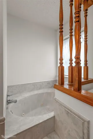 a bathroom with a bathtub and shower