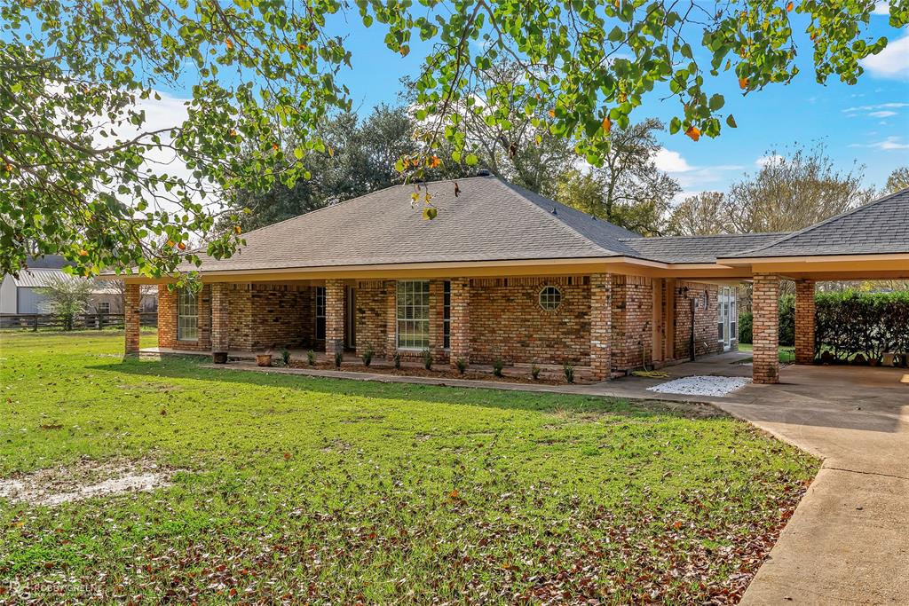 5425 Modica Lott Road Bossier City, LA 71111 - Photo 3 of 31 a front view of a house with a garden