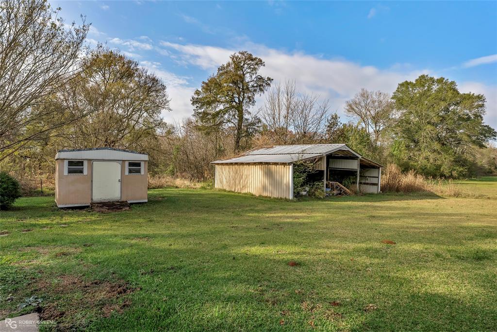 5425 Modica Lott Road Bossier City, LA 71111 - Photo 5 of 31 a front view of a house with a garden