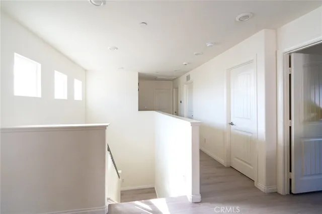 a view of a kitchen with furniture and a refrigerator