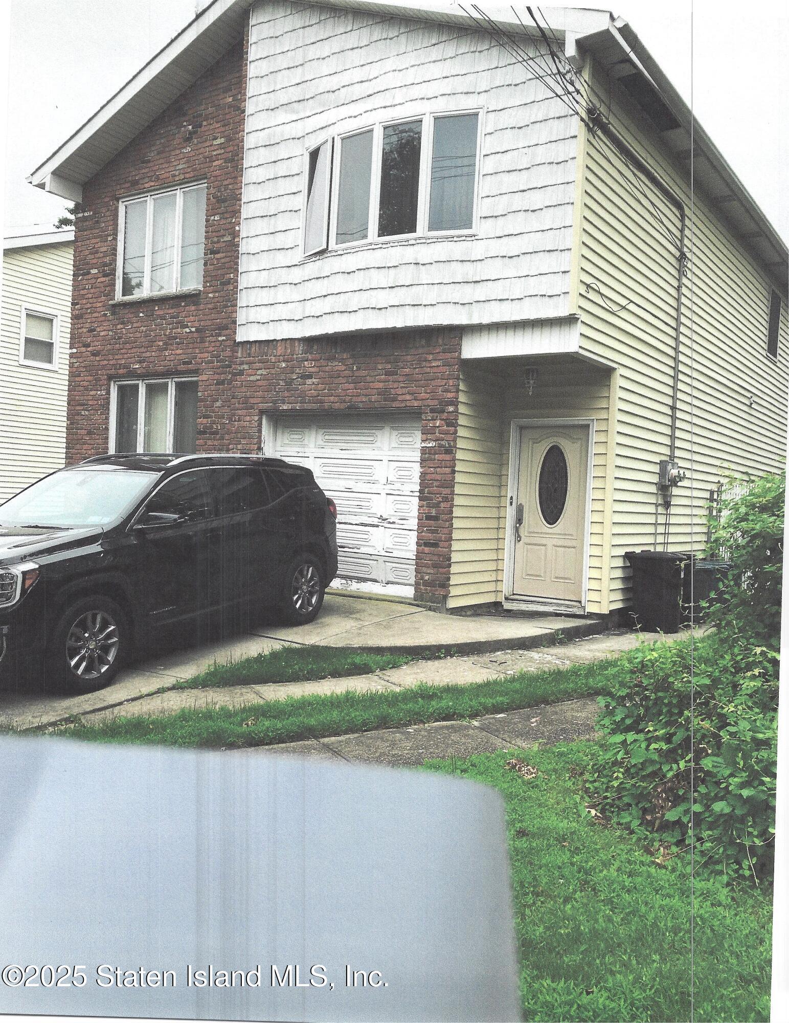 a front view of a house with a garden and plants