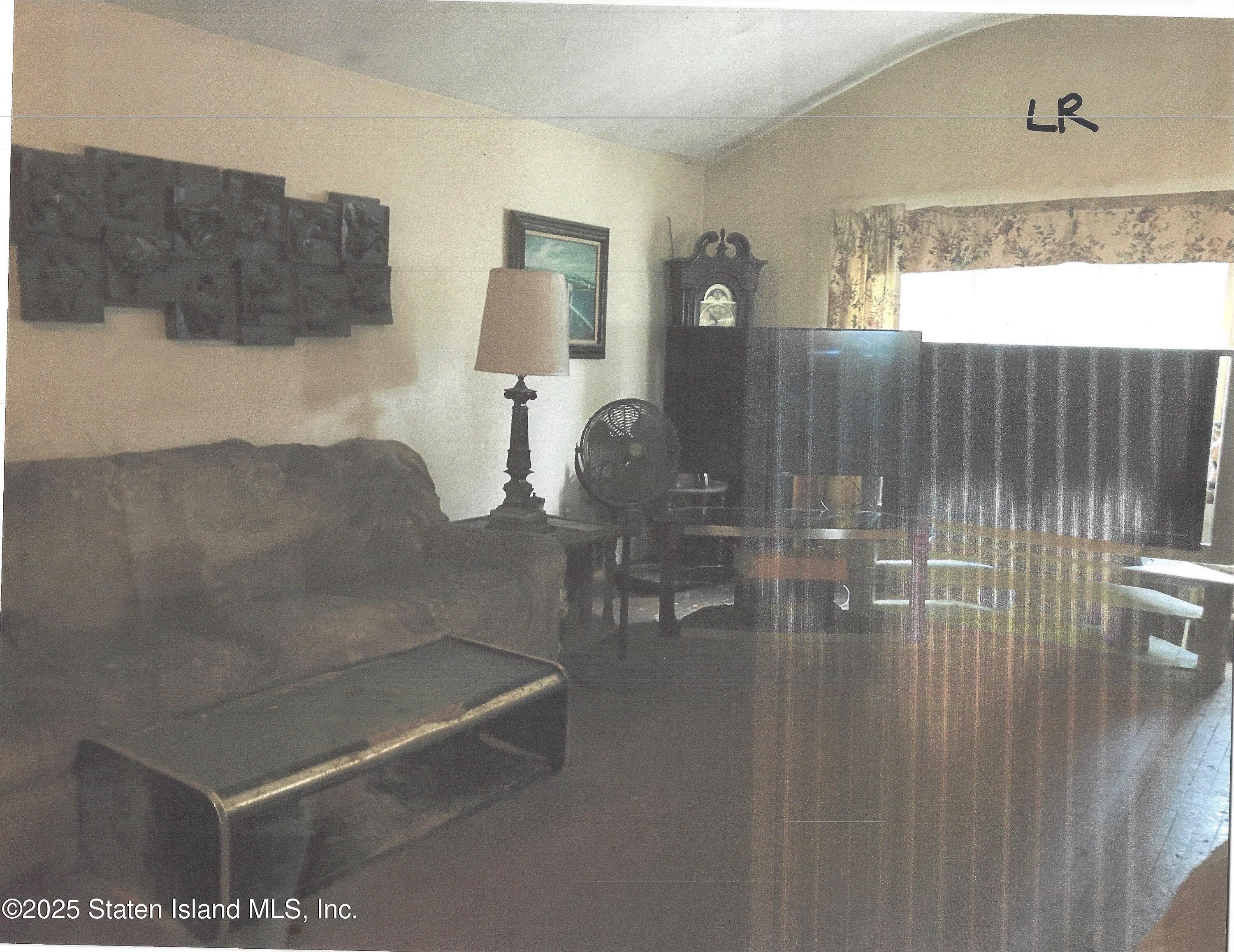 610 Woodrow Road Staten Island, NY 10312 - Photo 2 of 9 a bathroom with a sink a mirror and shower