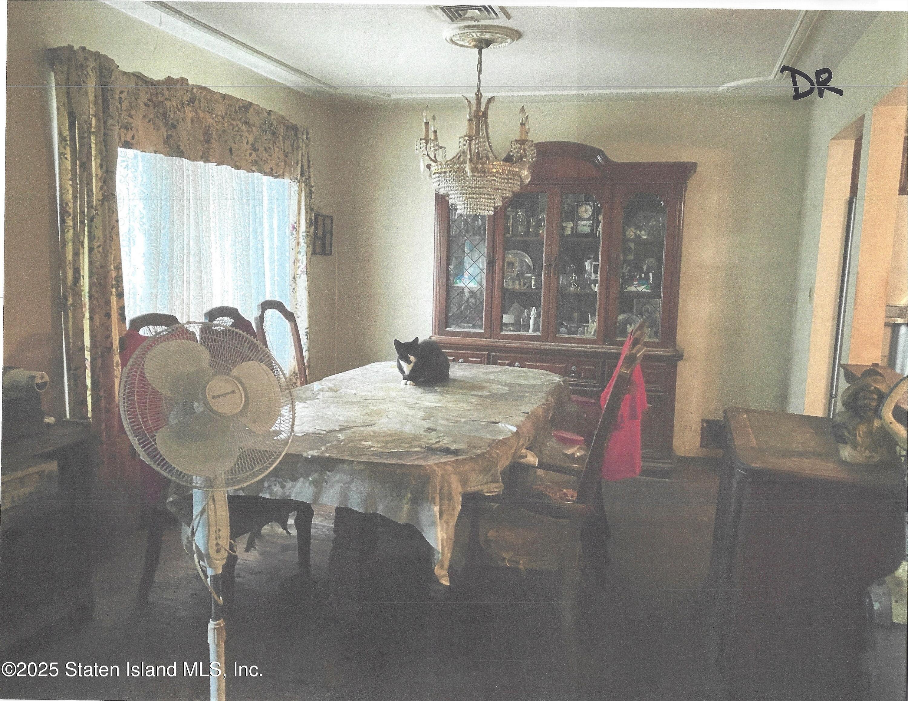 610 Woodrow Road Staten Island, NY 10312 - Photo 4 of 9 a view of a dining room with furniture and chandelier