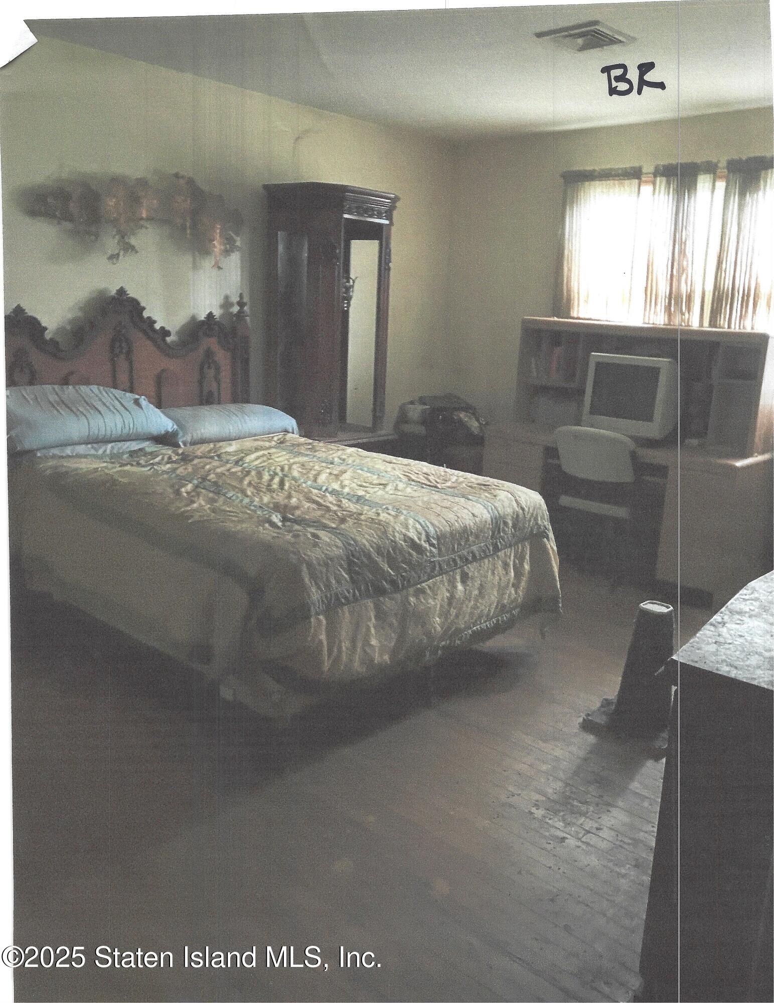 610 Woodrow Road Staten Island, NY 10312 - Photo 5 of 9 a bedroom with a bed and window