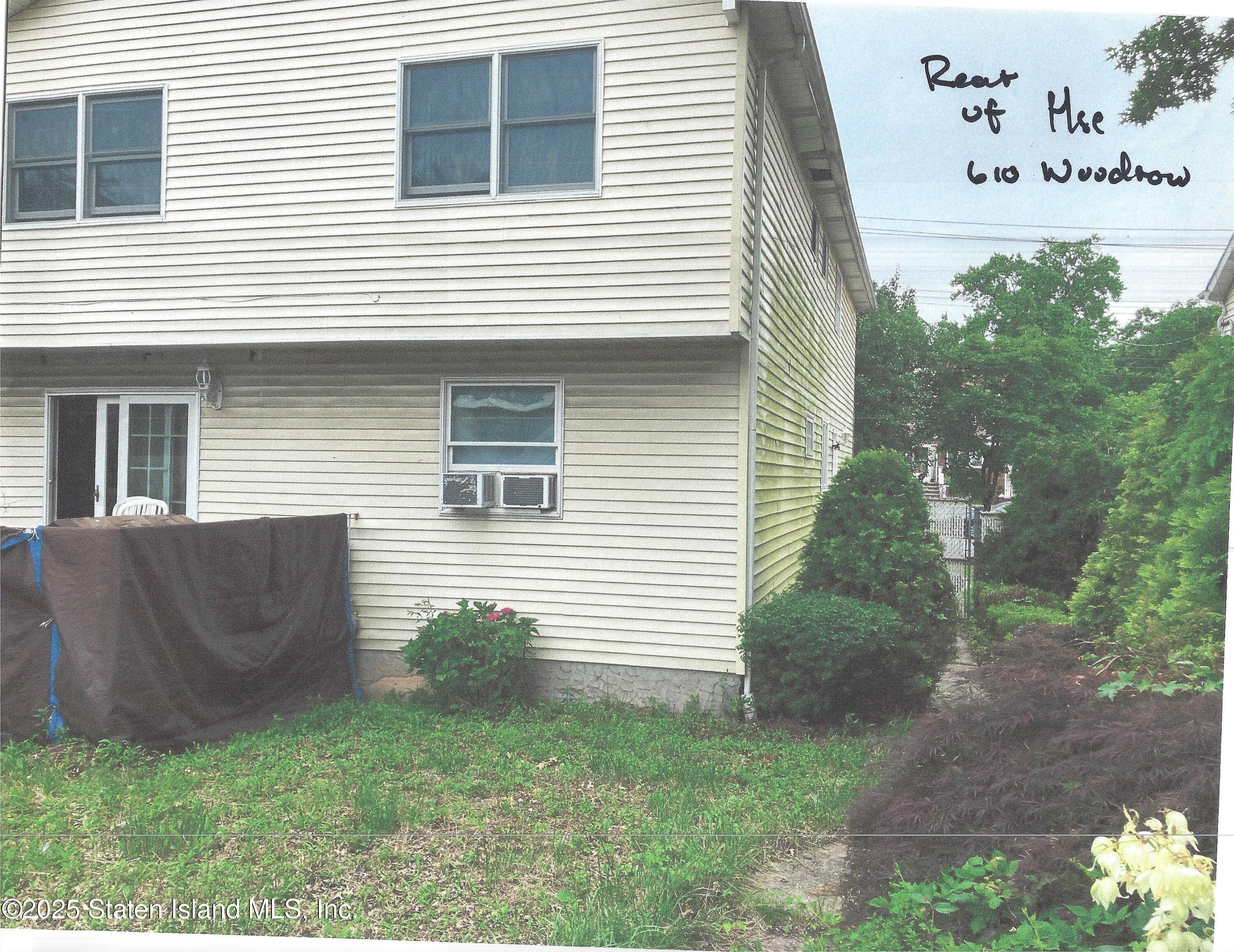610 Woodrow Road Staten Island, NY 10312 - Photo 8 of 9 a view of a house with a yard